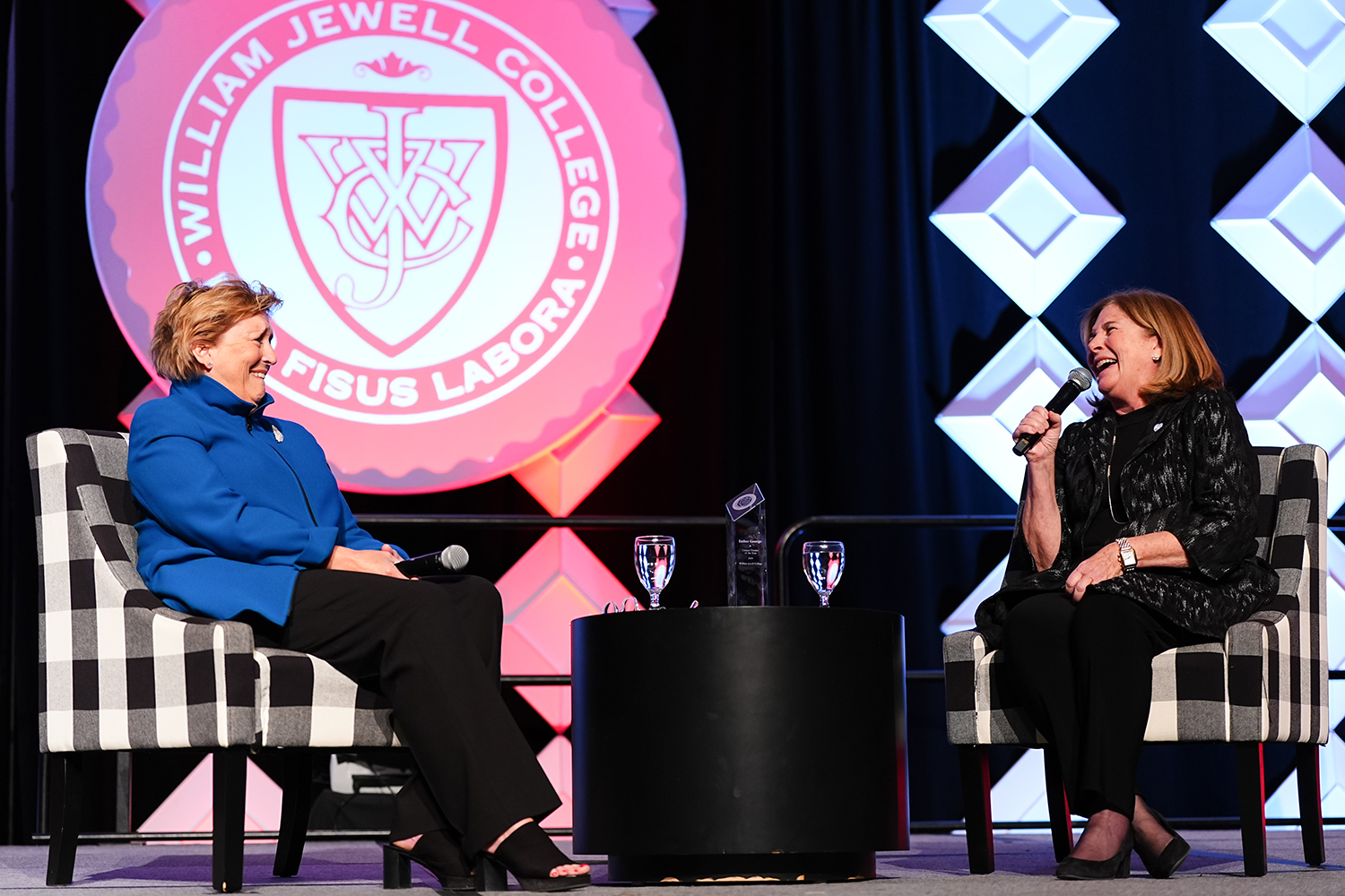 Susan Chambers and Esther George seated on stage