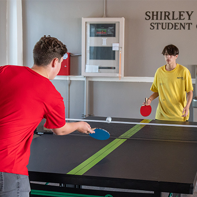 students playing ping pong in dorm lobby