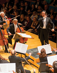 Conductor with symphony in large theater