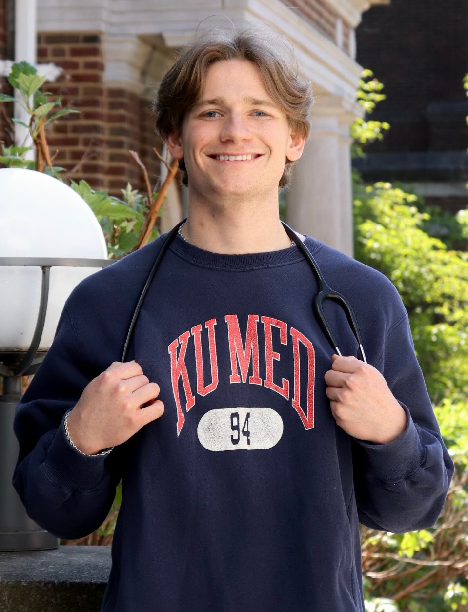 Carson Krop in KU Med T-shirt with stethoscope around neck